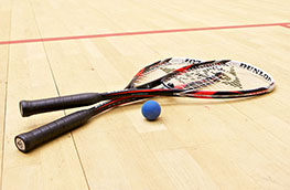 Squash rackets and ball on a squash court