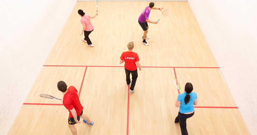 Players on a court playing Squash 101