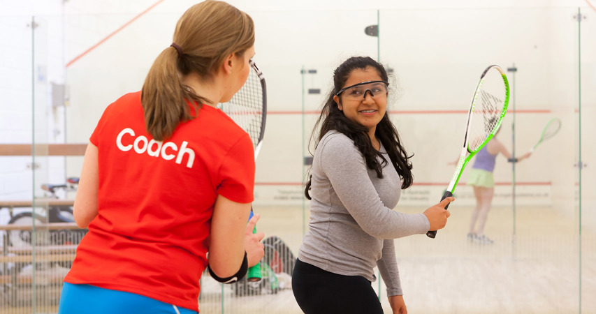 Female coach coaching a young teen