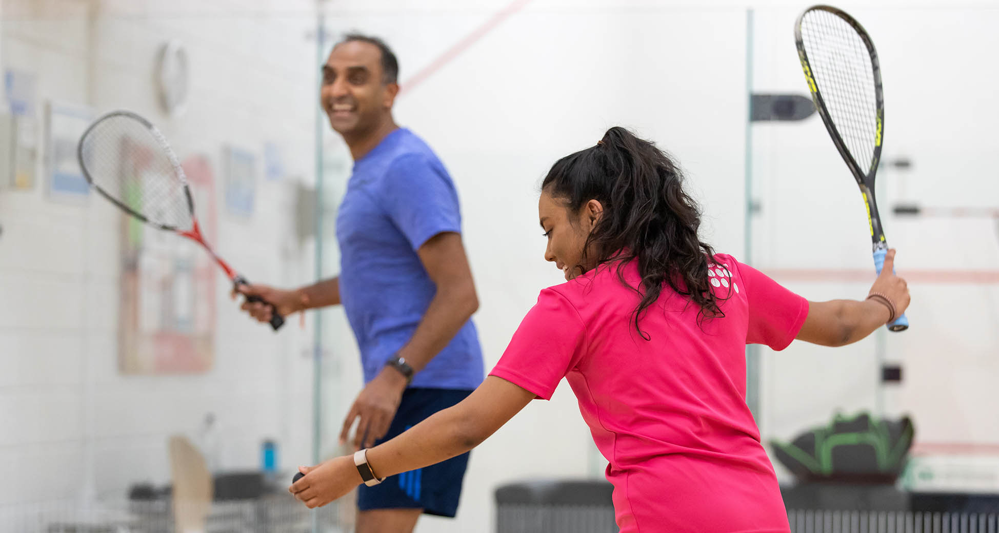 Man and woman playing squash