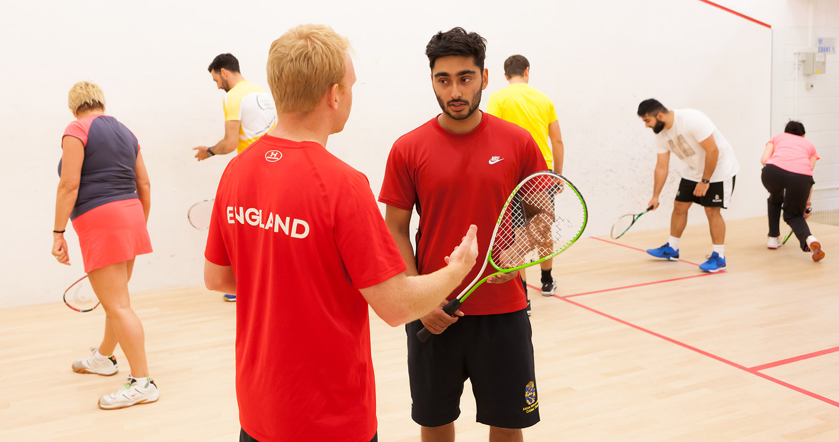 England coach tutoring a squash course