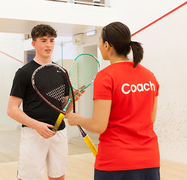 Female coach talking to young player